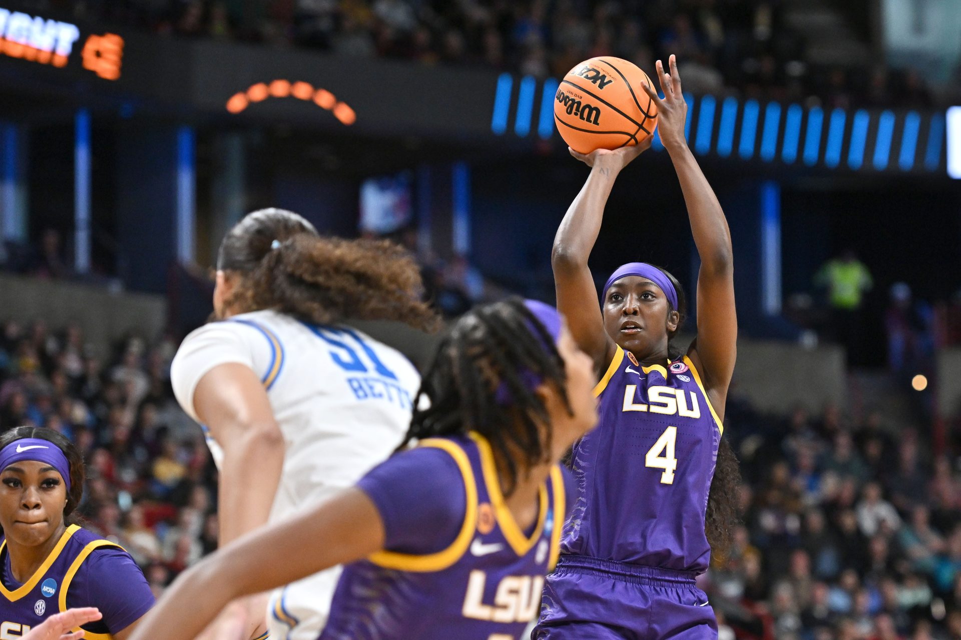 Mar 30, 2025; Spokane, WA, USA; LSU Lady Tigers guard Flau'Jae Johnson (4) shoots against UCLA Bruins center Lauren Betts (51) during the second half of a Elite 8 NCAA Tournament basketball game at Spokane Arena.