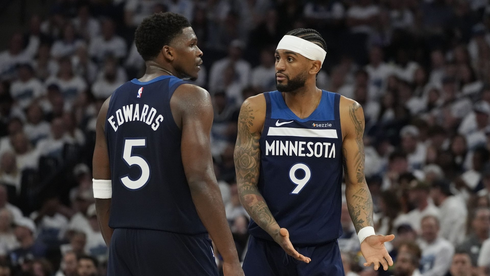 May 26, 2025; Minneapolis, Minnesota, USA; Minnesota Timberwolves guard Nickeil Alexander-Walker (9) and guard Anthony Edwards (5) talk against the Oklahoma City Thunder in the second half during game four of the western conference finals for the 2025 NBA Playoffs at Target Center.