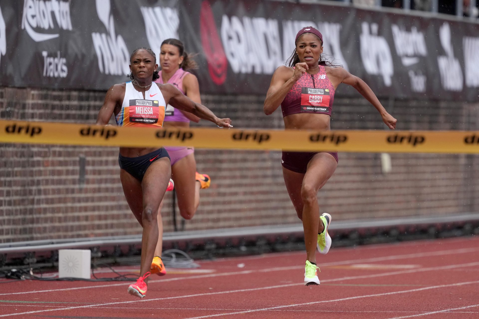 May 31, 2025; Philadelphia, PA, USA; Melissa Jefferson-Wooden (USA), left, defeats Gabby Thomas (USA) to win the women's 200m, 21.99 to 22.10, during the Grand Slam Track Philadelphia at Franklin Field.