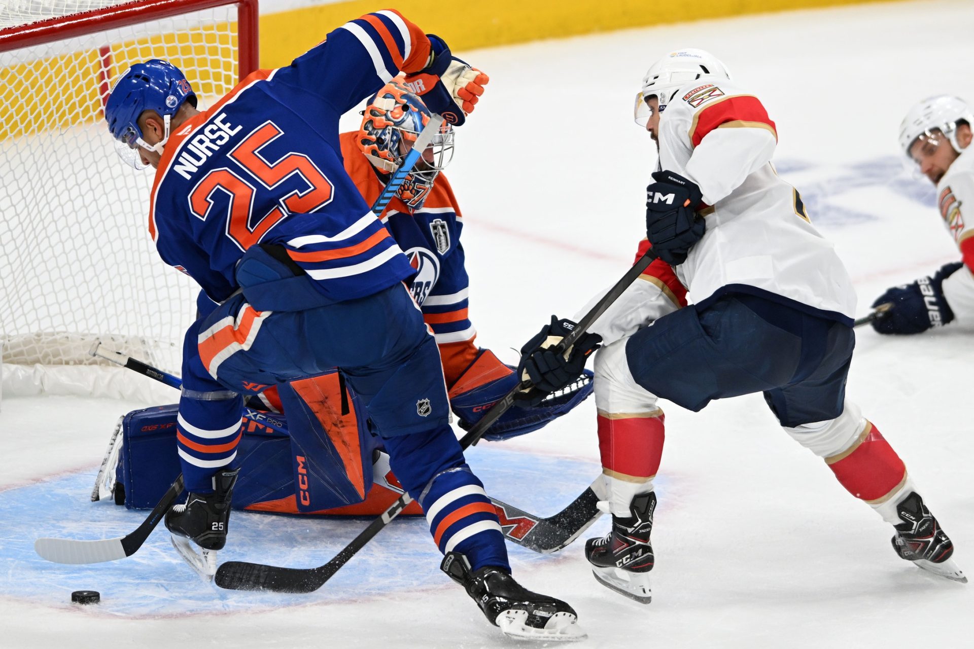 Jun 4, 2025; Edmonton, Alberta, CAN; Edmonton Oilers defenseman Darnell Nurse (25) deflects a shot against the Florida Panthers during the second period in game one of the 2025 Stanley Cup Final at Rogers Place.