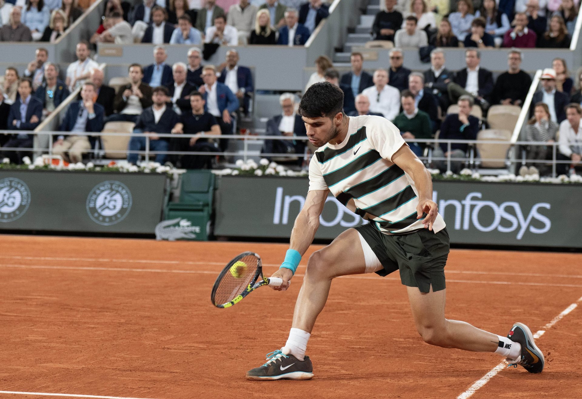 Jun 6, 2025; Paris, FR; Carlos Alcaraz of Spain returns a shot during his match against Lorenzo Musetti of Italy match on day 13 at Roland Garros Stadium.