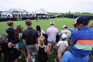 Jun 9, 2025; Oakmont, Pennsylvania, USA; Fans look on as Bryson DeChambeau practices on the practice green during a practice round for the U.S. Open golf tournament at Oakmont Country Club.