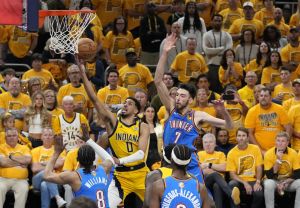 Jun 13, 2025; Indianapolis, Indiana, USA; Indiana Pacers guard Tyrese Haliburton (0) drives to the hoop past Oklahoma City Thunder forward Jalen Williams (8), guard Shai Gilgeous-Alexander (2) and forward Chet Holmgren (7) during the third quarter of game four of the 2025 NBA Finals at Gainbridge Fieldhouse.