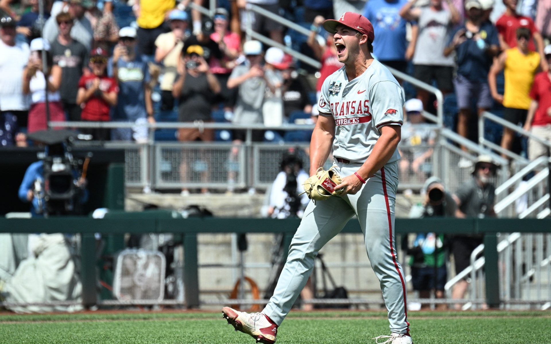 Jun 16, 2025; Omaha, Neb, USA; Arkansas Razorbacks starting pitcher Gage Wood (14) celebrates completing a no hitter against the Murray State Racers at Charles Schwab Field.