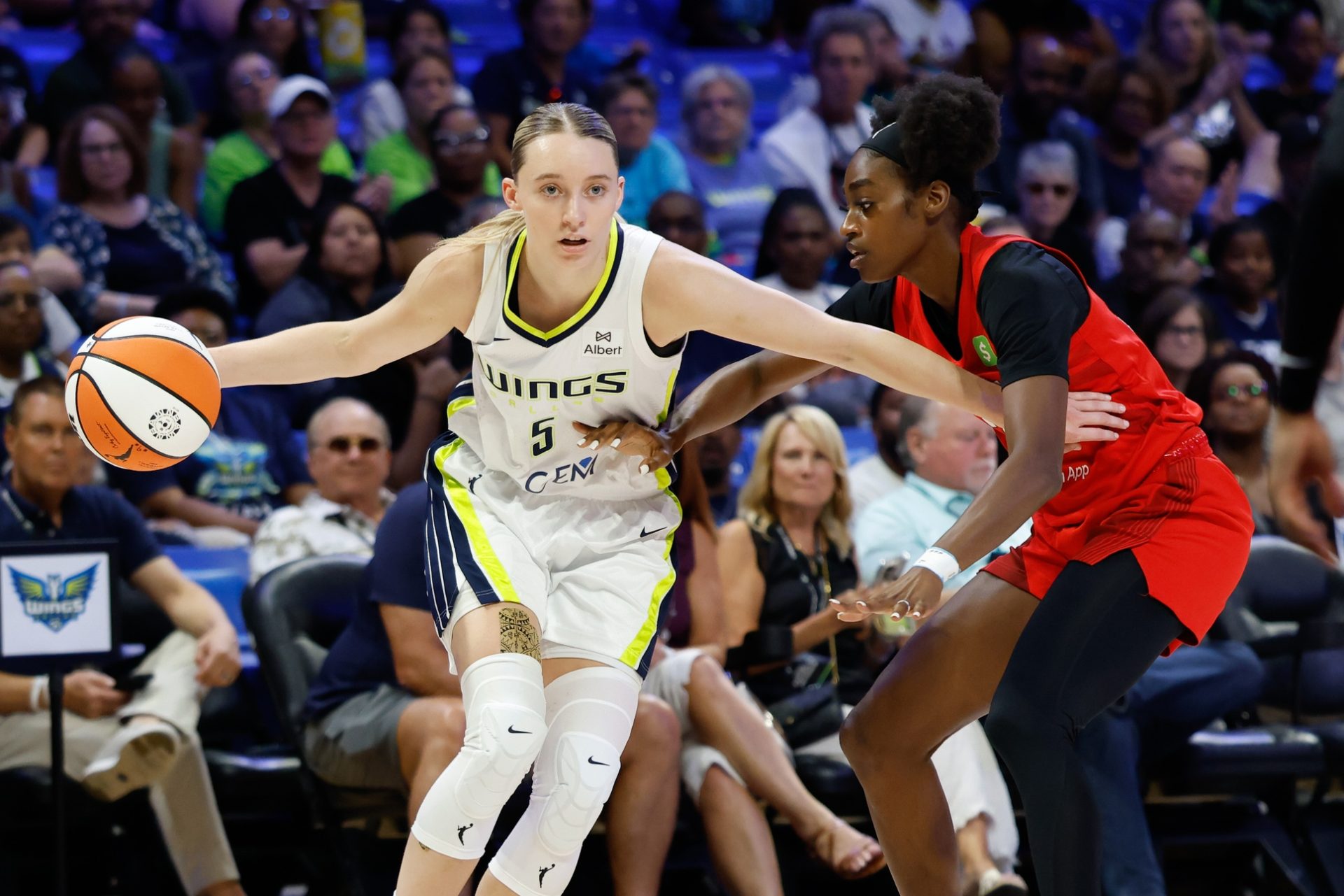 Jun 24, 2025; Arlington, Texas, USA; Dallas Wings guard Paige Bueckers (5) controls the ball as Atlanta Dream guard Maya Caldwell (33) defends during the first half at College Park Center.