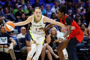 Jun 24, 2025; Arlington, Texas, USA; Dallas Wings guard Paige Bueckers (5) controls the ball as Atlanta Dream guard Maya Caldwell (33) defends during the first half at College Park Center.