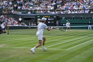 Jul 3, 2022; London, United Kingdom; Jannik Sinner (ITA) returns a shot during his match against Carlos Alcaraz (ESP) on day seven at All England Lawn Tennis and Croquet Club.