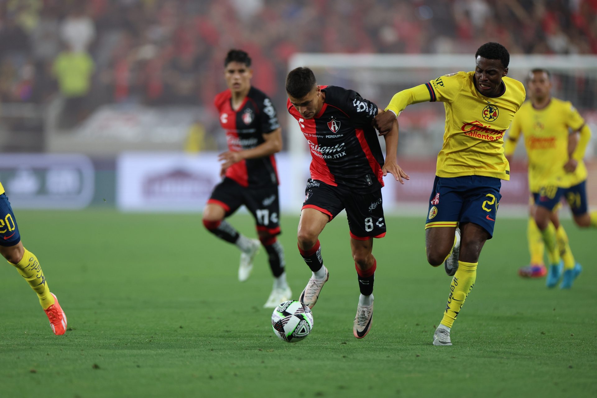 Aug 9, 2024; San Diego, California, USA; Atlas FC midfielder Mateo Garcia (8) dribbles the ball on Club America forward Javairo Dilrosun (24) in the second half at Snapdragon Stadium.