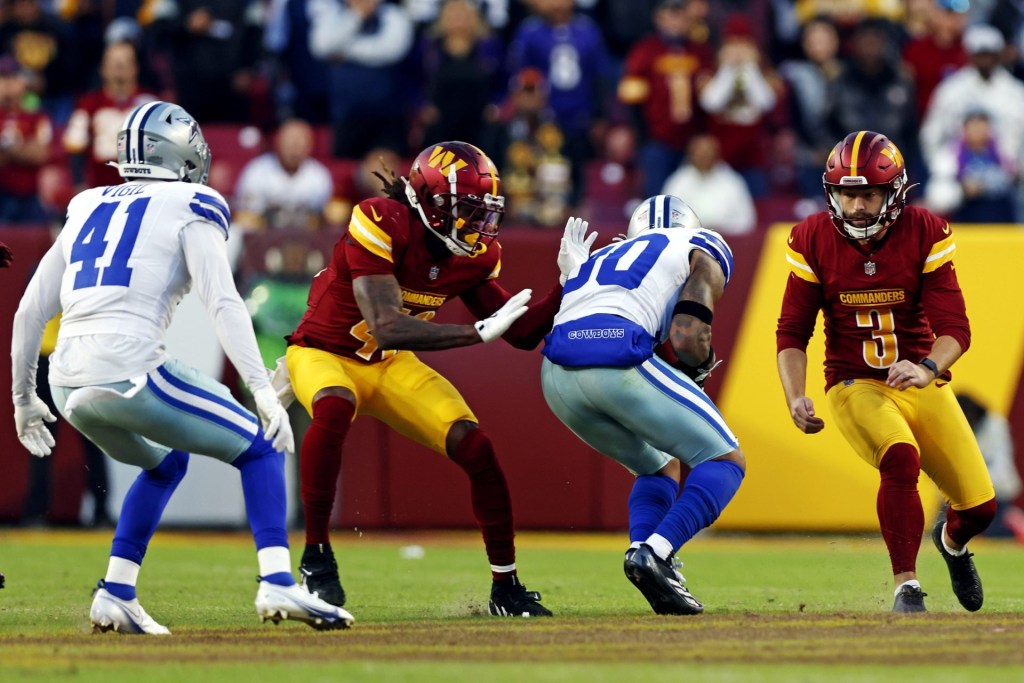 Nov 24, 2024; Landover, Maryland, USA; Dallas Cowboys safety Juanyeh Thomas (30) recovers an onside kick by Washington Commanders place kicker Austin Seibert (3) and returns it for a touchdown during the fourth quarter at Northwest Stadium.