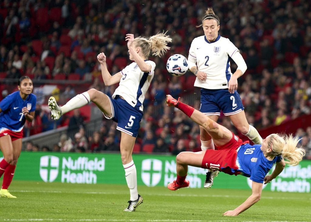 Nov 30, 2024; London, England; United states midfielder Lindsey Horan (10) with an overhead kick to shoot on gaol under pressure from England substitute Nikita Parris England defender Leah Williamson (5) and England defender Lucy Bronze (2) in the first half of an International friendly at Wembley Stadium.
