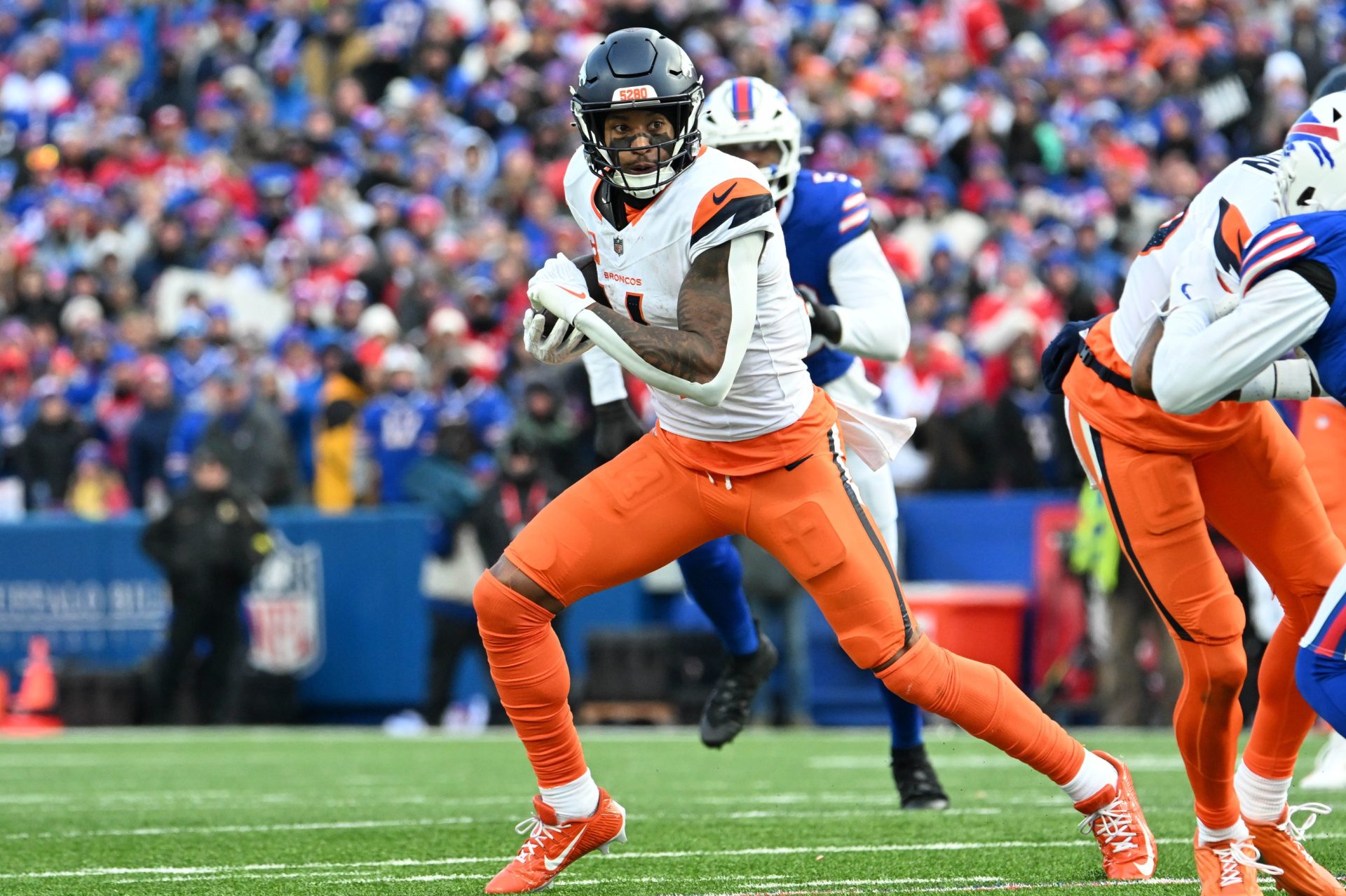 Jan 12, 2025; Orchard Park, New York, USA; Denver Broncos wide receiver Courtland Sutton (14) runs after making a catch in the fourth quarter of an AFC wild card game against the Buffalo Bills at Highmark Stadium.