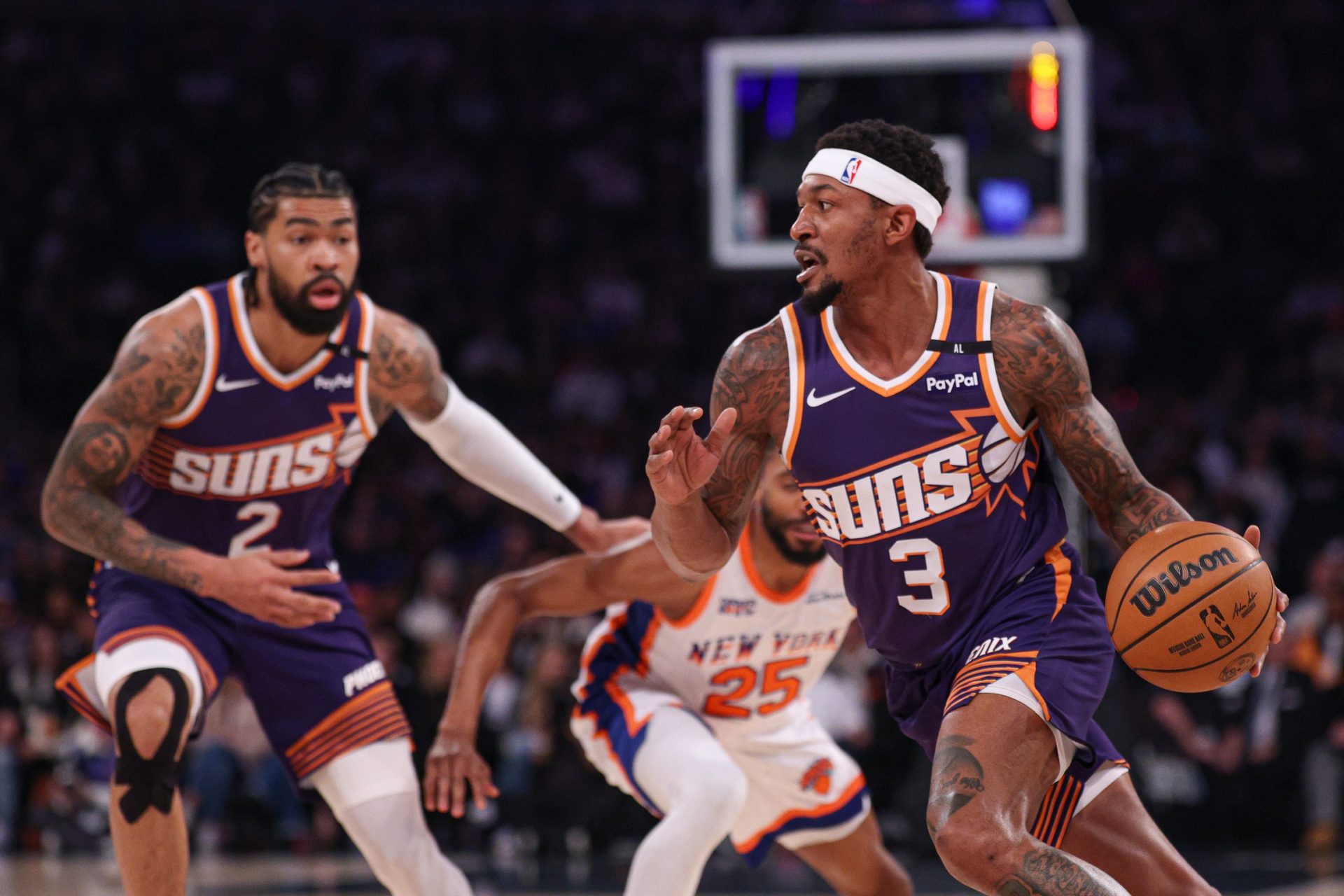 Apr 6, 2025; New York, New York, USA; Phoenix Suns guard Bradley Beal (3) dribbles as New York Knicks forward Mikal Bridges (25) is screened by Phoenix Suns center Nick Richards (2) during the first half at Madison Square Garden.