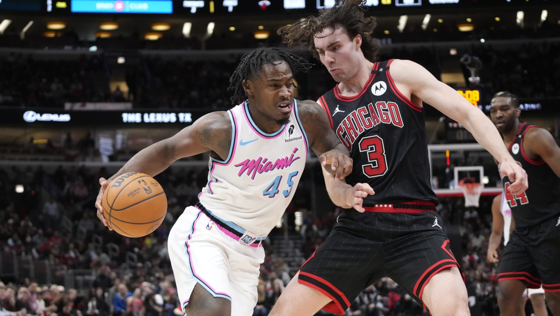 Apr 9, 2025; Chicago, Illinois, USA; Chicago Bulls guard Josh Giddey (3) defends Miami Heat guard Davion Mitchell (45) during the second half at United Center.