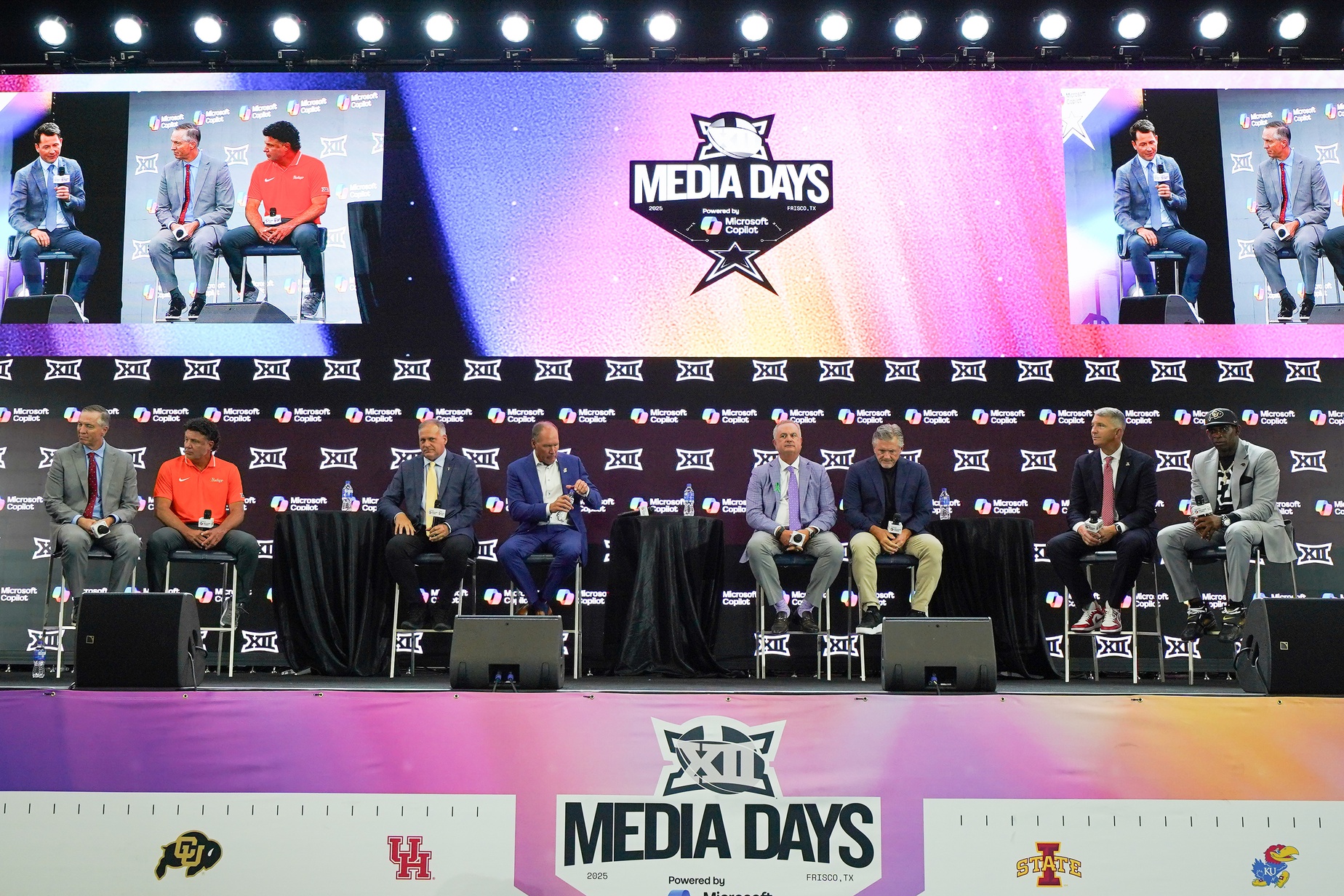 Jul 9, 2025; Frisco, TX, USA; Head coaches Willie Fritz of Houston, Mike Gundy of Oklahoma State, Rich Rodriguez of West Virginia, Lance Leipold of Kansas, Sonny Dykes of TCU, Kyle Whittingham of Utah, Brent Brennan of Arizona and Deion Sanders of Colorado all sit on stage for a Coaches Roundtable during 2025 Big 12 Football Media Days at The Star.