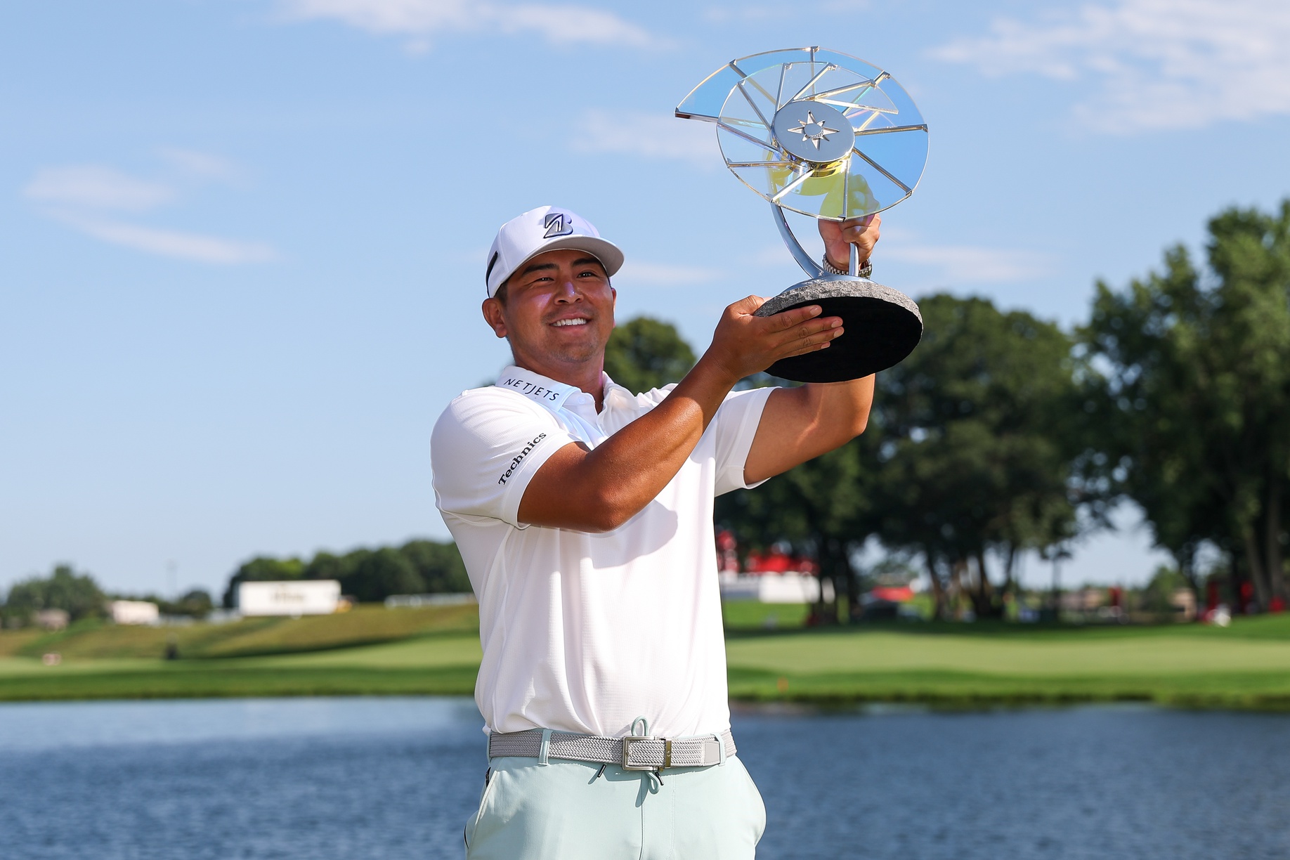 Jul 27, 2025; Blaine, Minnesota, USA; Kurt Kitayama celebrates with the trophy after winning the 3M Open golf tournament. Mandatory Credit: