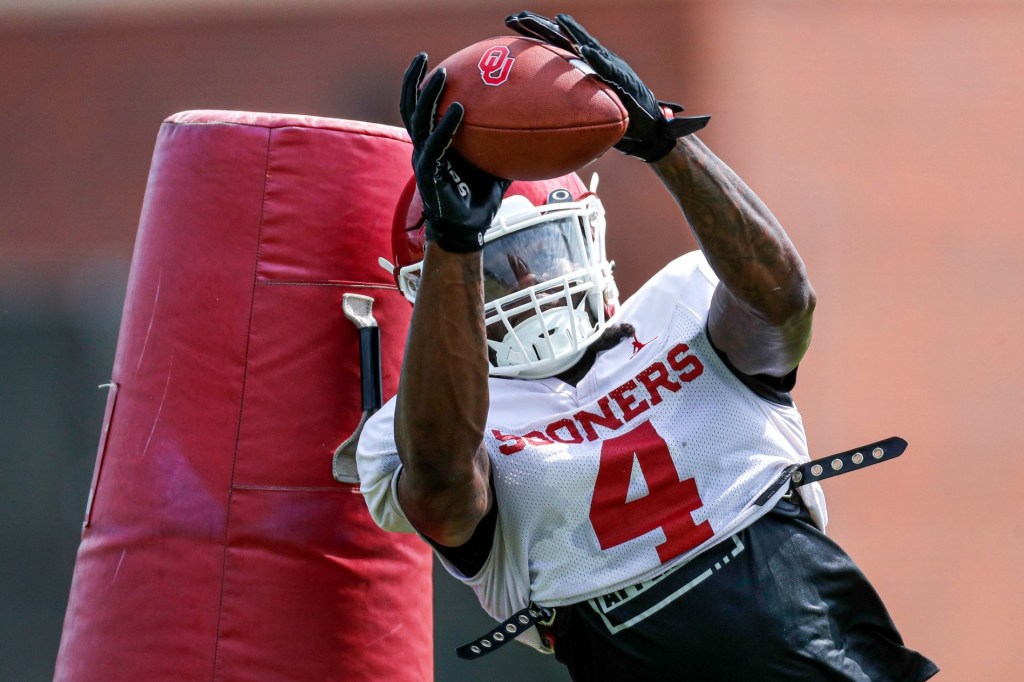 Justin Harrington (4) runs drills during an OU football practice in Norman, Okla., on Monday, Aug. 7, 2023.