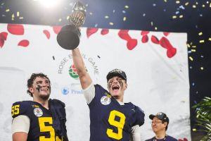 Michigan quarterback J.J. McCarthy lifts the Rose Bowl trophy to celebrate after the team's defeat of Alabama in the College Football Playoff semifinal at Rose Bowl Stadium in Pasadena, Calif., on Monday, Jan. 1, 2024.