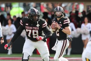 Nov 30, 2024; Lubbock, Texas, USA; Texas Tech Red Raiders offensive guard Sterling Porcher (79) blocks for quarterback Behren Morton (2) in the second half during the game against the West Virginia Mountaineers at Jones AT&T Stadium and Cody Campbell Field.