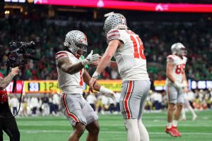 Jan 20, 2025; Atlanta, GA, USA; Ohio State Buckeyes running back Quinshon Judkins (1) and quarterback Will Howard (18) celebrate after a touchdown against the Notre Dame Fighting Irish during the second half the CFP National Championship college football game at Mercedes-Benz Stadium.