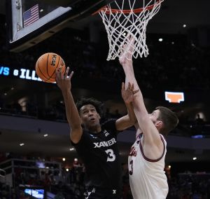 Mar 21, 2025; Milwaukee, WI, USA; Illinois center Tomislav Ivisic (13) attempts to block Xavier guard Dailyn Swain (3) during the second half of their first round NCAA men’ s basketball tournament game at Fiserv Forum.