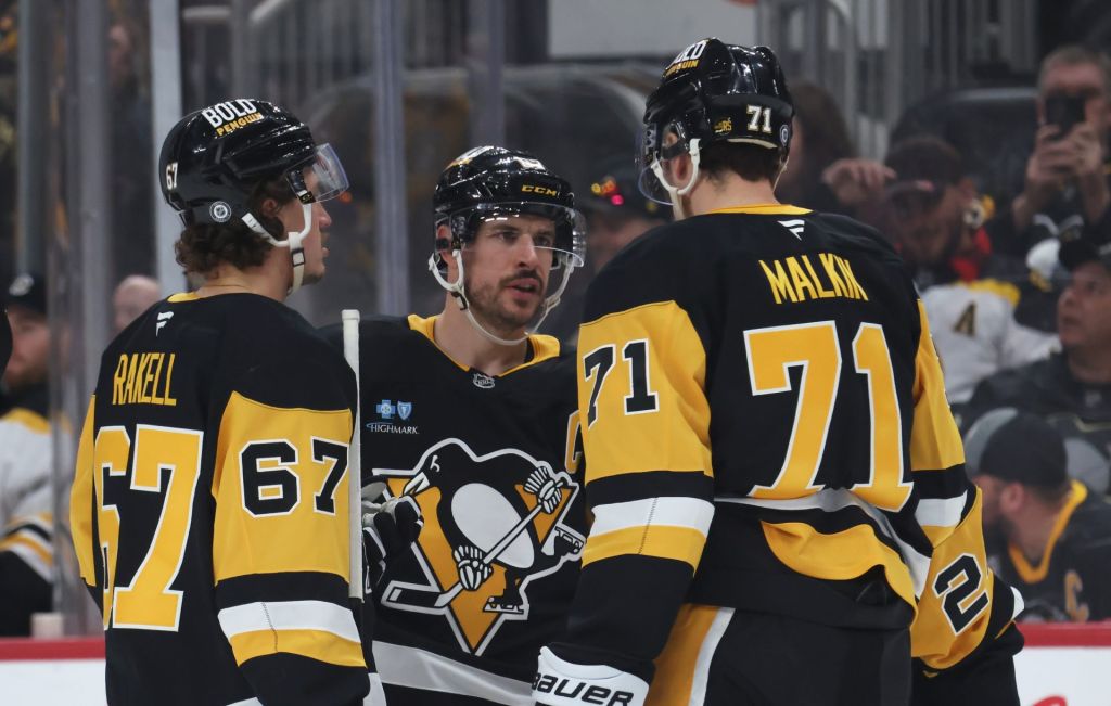 Apr 13, 2025; Pittsburgh, Pennsylvania, USA; Pittsburgh Penguins right wing Rickard Rakell (67) and center Sidney Crosby (87) and center Evgeni Malkin (71) talk before a face-off against the Boston Bruins during the third period at PPG Paints Arena.