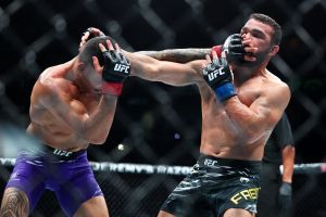 Jul 19, 2025; New Orleans, Louisiana, UNITED STATES; Dan Ige (red gloves) fights against Patricio Pitbull (blue gloves) during UFC 318 at Smoothie King Center.