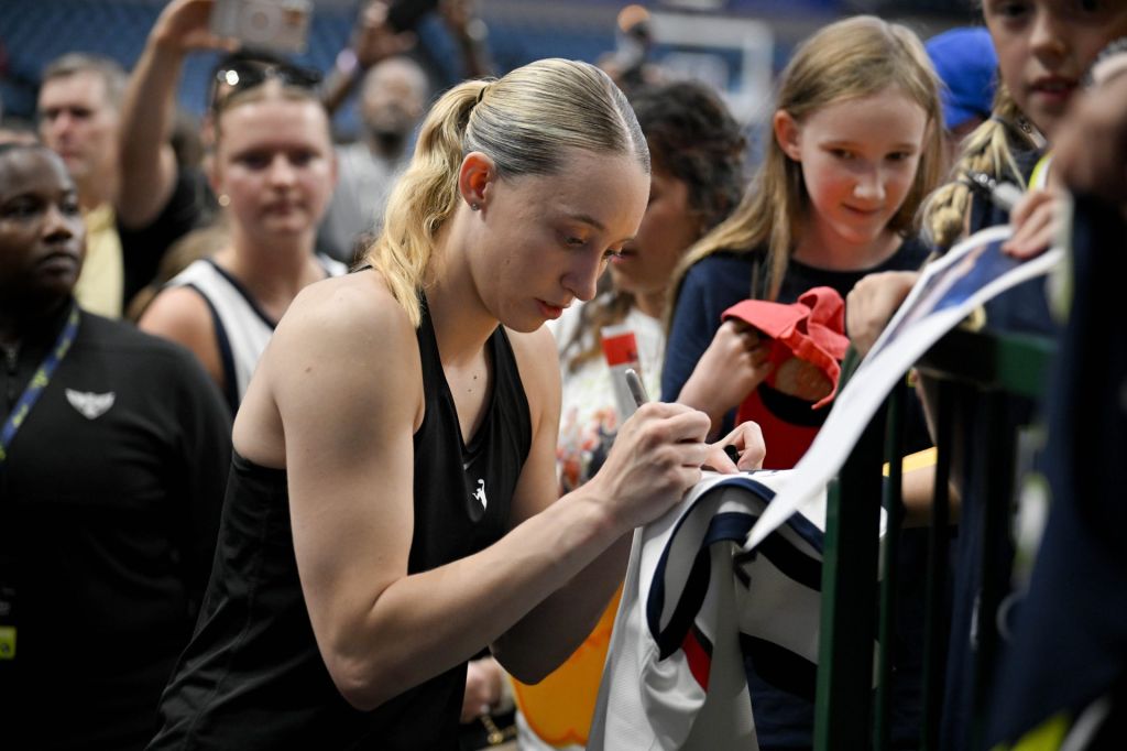 Aug 1, 2025; Dallas, Texas, USA; Dallas Wings guard Paige Bueckers (5) signs autographs for fans before the game against the Indiana Fever at the American Airlines Center.
