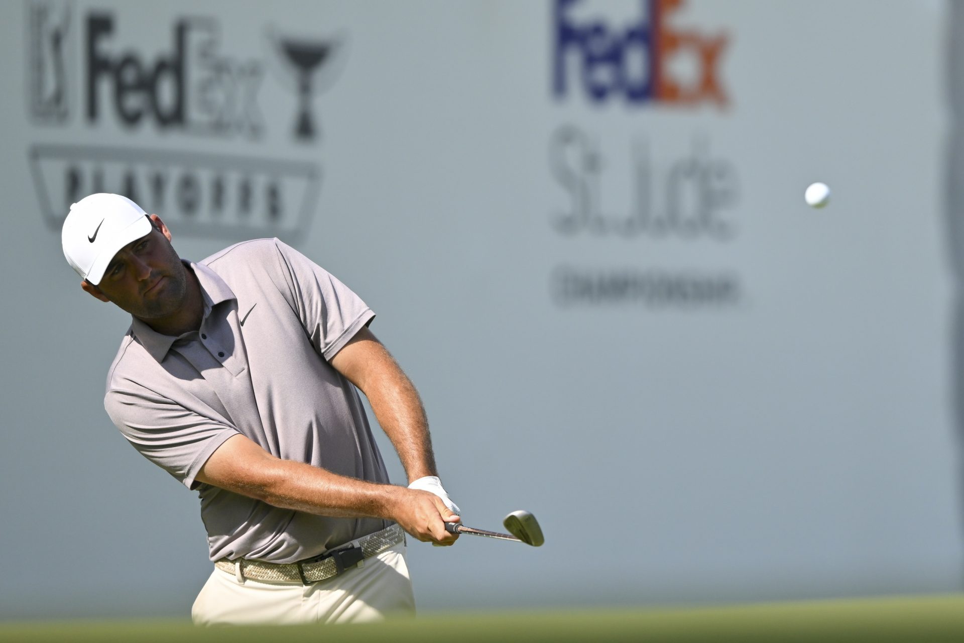 Aug 10, 2025; Memphis, Tennessee, USA; Scottie Scheffler chips from the rough on 17th hole during the final round of the FedEx St. Jude Championship golf.