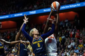 Aug 17, 2025; Uncasville, Connecticut, USA; Connecticut Sun center Tina Charles (31) and Indiana Fever guard Sophie Cunningham (8) work for the ball in the first half at Mohegan Sun Arena.