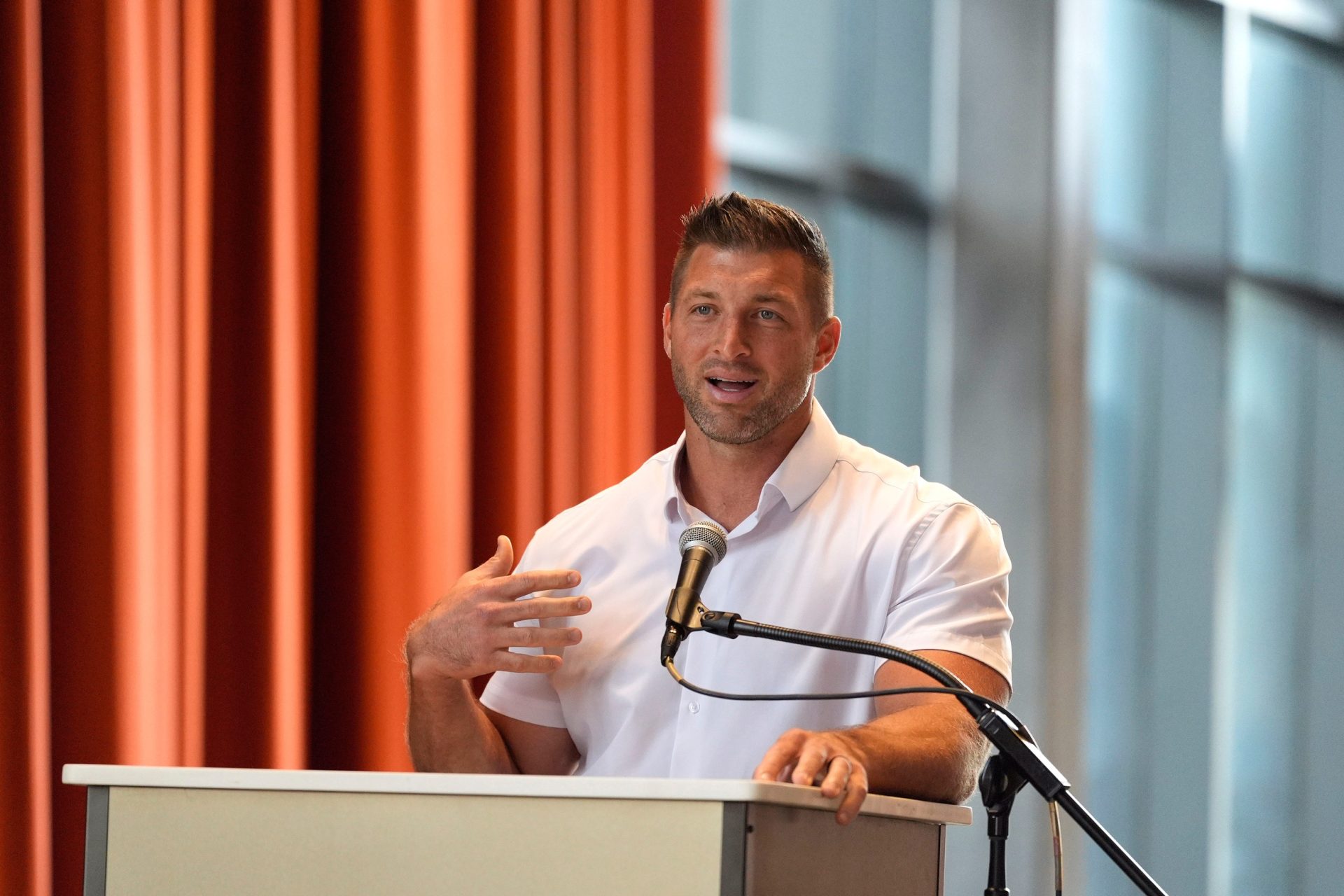 Aug 20, 2025; Augusta, Georgia, USA; Tim Tebow, former NFL quarterback and Co-Owner of Augusta Pro Hockey, speaks during the announcement for Augusta Pro Hockey at the Bell Auditorium. ECHL hockey will return to Augusta for the 2027-2028 season.