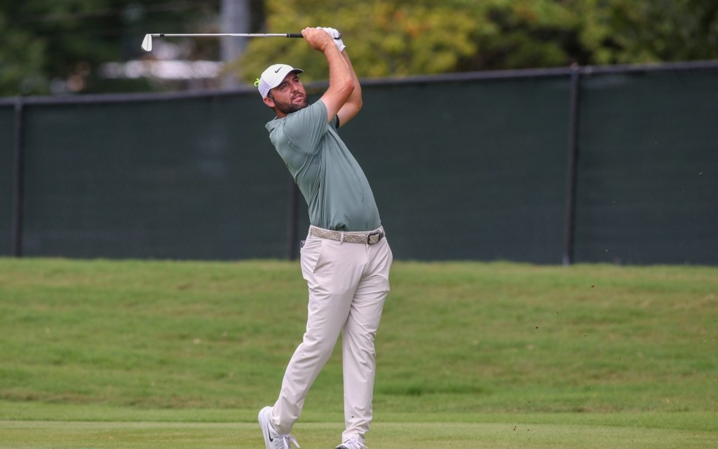 Aug 24, 2025; Atlanta, Georgia, USA; Scottie Scheffler takes his shot on the first hole during the final round of the TOUR Championship golf tournament.