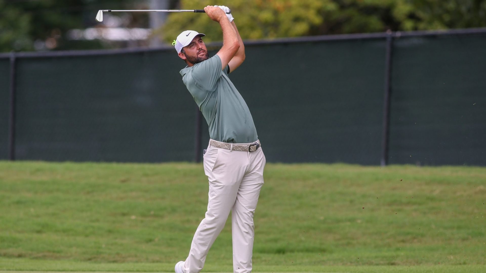 Aug 24, 2025; Atlanta, Georgia, USA; Scottie Scheffler takes his shot on the first hole during the final round of the TOUR Championship golf tournament.