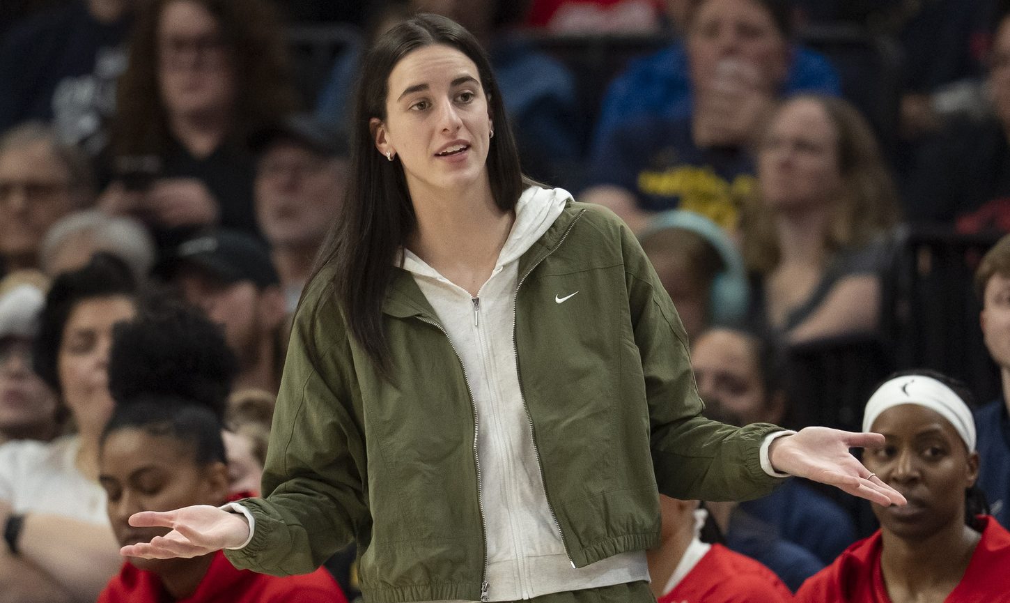 Aug 24, 2025; Minneapolis, Minnesota, USA; Indiana Fever guard Caitlin Clark (22) looks on from the bench against the Minnesota Lynx in the second half at Target Center.
