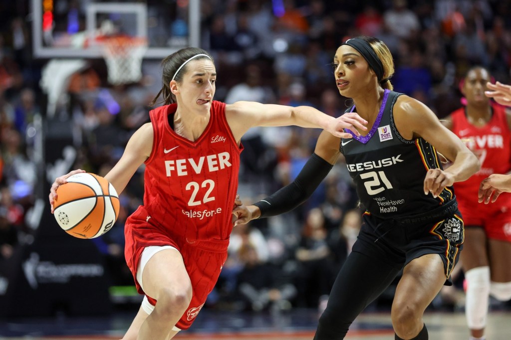 Sep 25, 2024; Uncasville, Connecticut, USA; Indiana Fever guard Caitlin Clark (22) drives to the basket defended by Connecticut Sun guard DiJonai Carrington (21) during the first half during game two of the first round of the 2024 WNBA Playoffs at Mohegan Sun Arena
