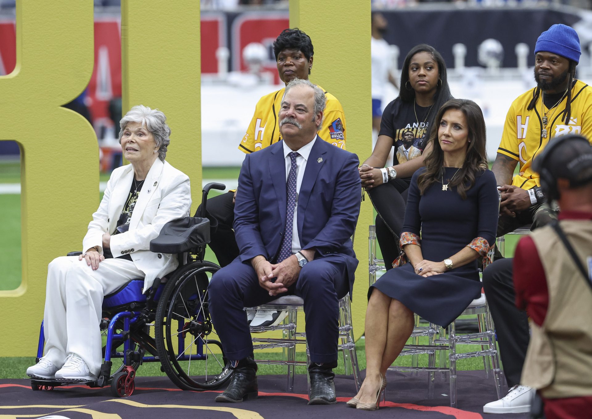 Oct 27, 2024; Houston, Texas, USA; Houston Texans co-founder and former owner Janice McNair (left) sits with Texans chief executive officer Cal McNair and wife Hannah McNair in front of family members of Texans former player Andre Johnson (not pictured) during a ceremony at halftime of the game against the Indianapolis Colts at NRG Stadium.