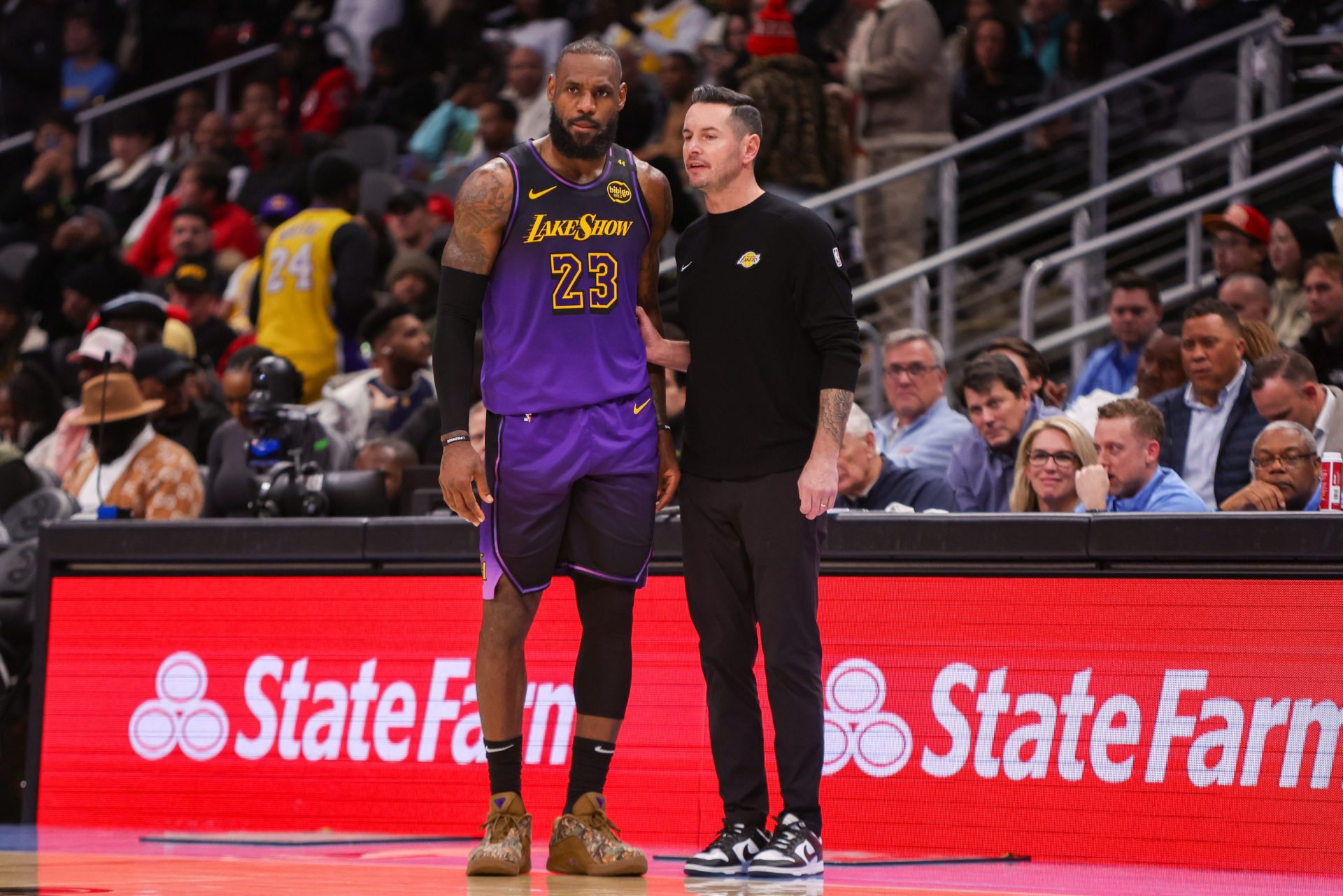 Dec 6, 2024; Atlanta, Georgia, USA; Los Angeles Lakers forward LeBron James (23) talks to head coach JJ Redick against the Atlanta Hawks in the second quarter at State Farm Arena.