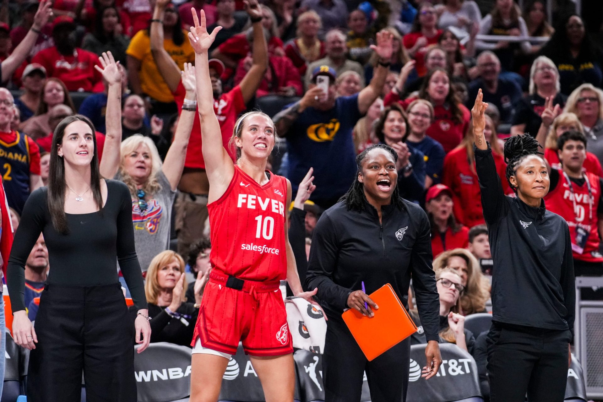 Indiana Fever guard Caitlin Clark (22), Indiana Fever guard Lexie Hull (10), Indiana Fever assistant coach Karima Christmas-Kelly and Indiana Fever assistant coach Briann January celebrate Friday, Sept. 5, 2025, during a game between the Indiana Fever and the Chicago Sky at Gainbridge Fieldhouse in Indianapolis. The Indiana Fever defeated the Chicago Sky, 97-77.