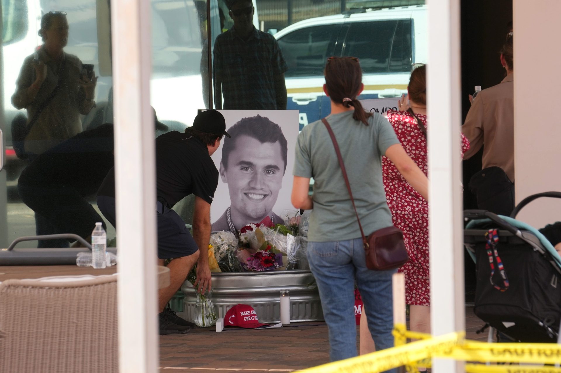 People congregate at Turning Point Headquarters in Phoenix after news that the founder, Charlie Kirk, was shot and killed at a rally in Utah on Sept. 10, 2025.