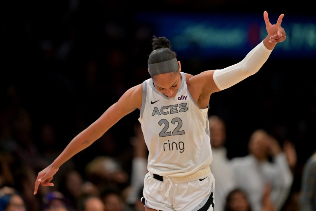 Sep 11, 2025; Los Angeles, California, USA; Las Vegas Aces center A'ja Wilson (22) celebrates after a 3 pointer during the second half against the Los Angeles Sparks at Crypto.com Arena