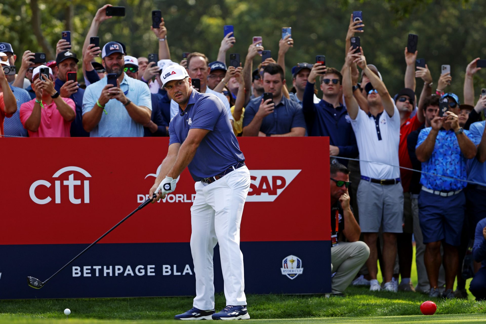 Sep 23, 2025; Bethpage, New York, USA; Bryson DeChambeau plays his shot from the 12th tee during a practice round of the Ryder Cup golf tournament at Bethpage Black.
