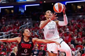 Sep 28, 2025; Indianapolis, Indiana, USA; Las Vegas Aces center A'ja Wilson (22) shoots the ball while Indiana Fever guard Kelsey Mitchell (0) defends in the second half during game four of the second round for the 2025 WNBA Playoffs at Gainbridge Fieldhouse.