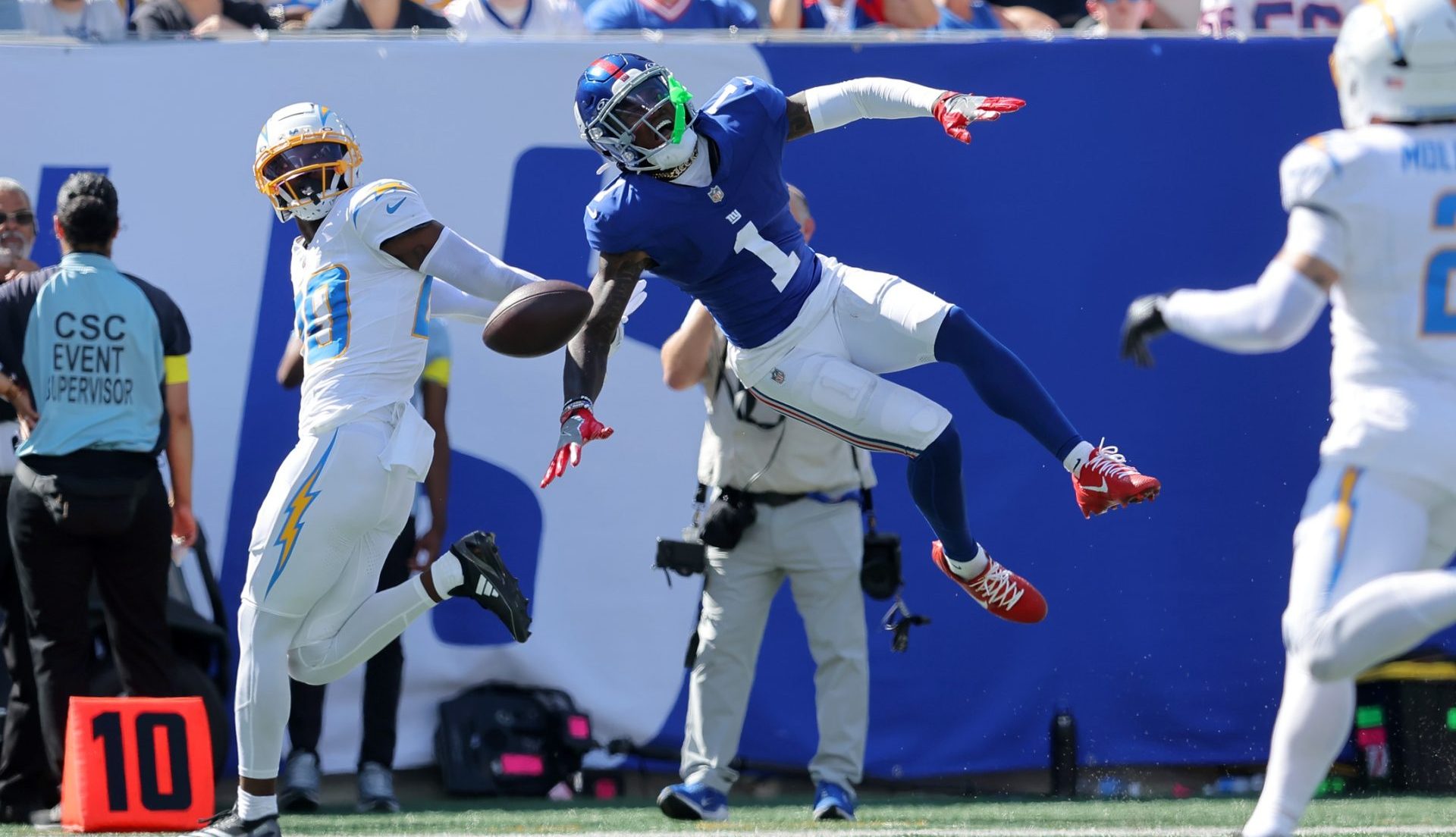 Sep 28, 2025; East Rutherford, New Jersey, USA; Los Angeles Chargers cornerback Cam Hart (20) breaks up a pass intended for New York Giants wide receiver Malik Nabers (1) during the second quarter at MetLife Stadium. Nabers was carted off the field with an injury after the play.