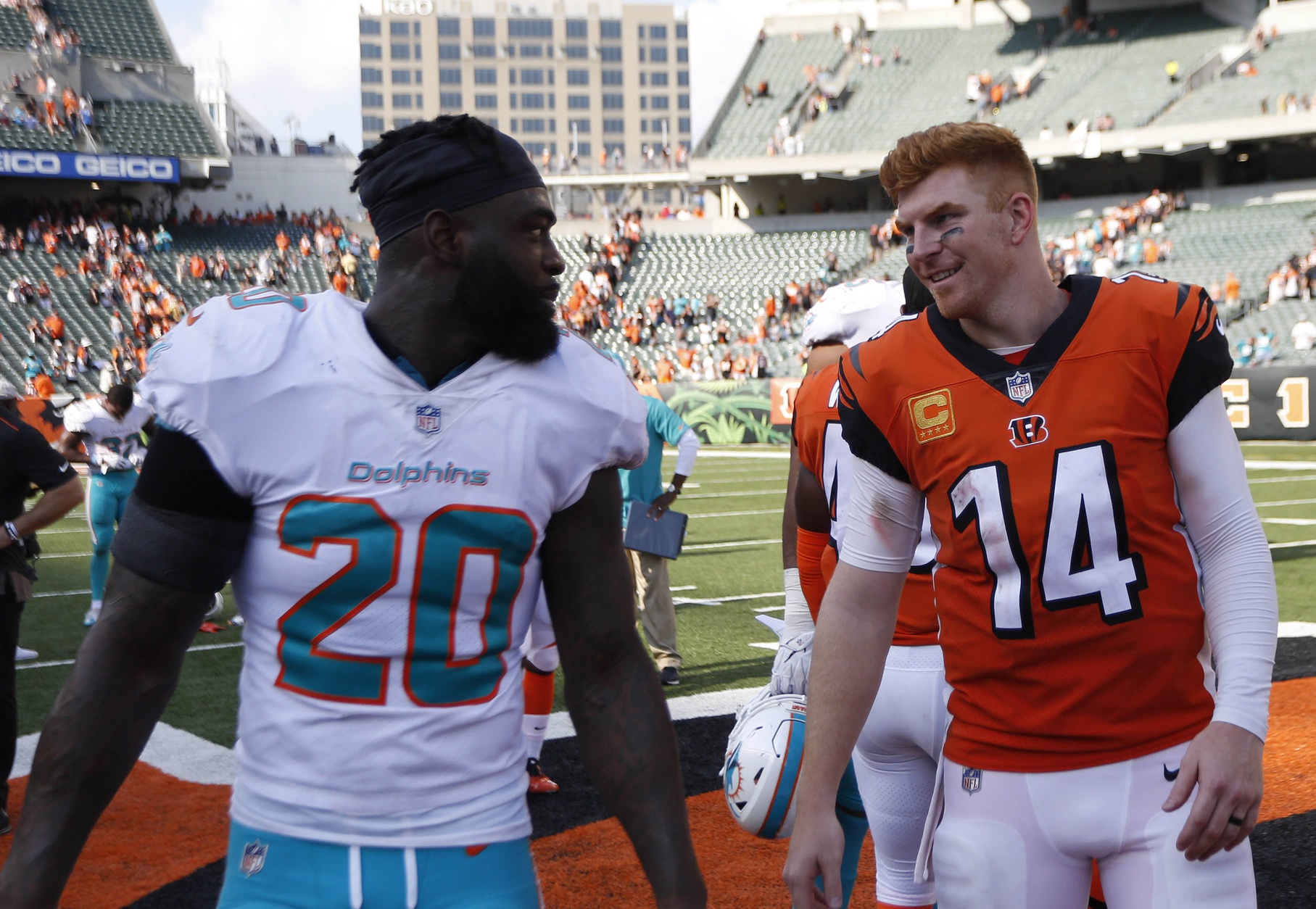 Oct 7, 2018; Cincinnati, OH, USA; Cincinnati Bengals quarterback Andy Dalton (14) and Miami Dolphins free safety Reshad Jones (20) talk with each other after the Bengals defeated the Dolphins at Paul Brown Stadium.