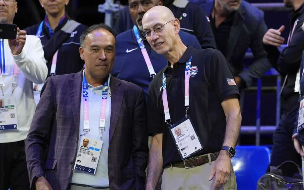 Aug 3, 2024; Villeneuve-d'Ascq, France; NBA commissioner Adam Silver talks to International Basketball Federation board member Mark Tatum in the fourth quarter between the United States and Puerto Rico during the Paris 2024 Olympic Summer Games at Stade Pierre-Mauroy.