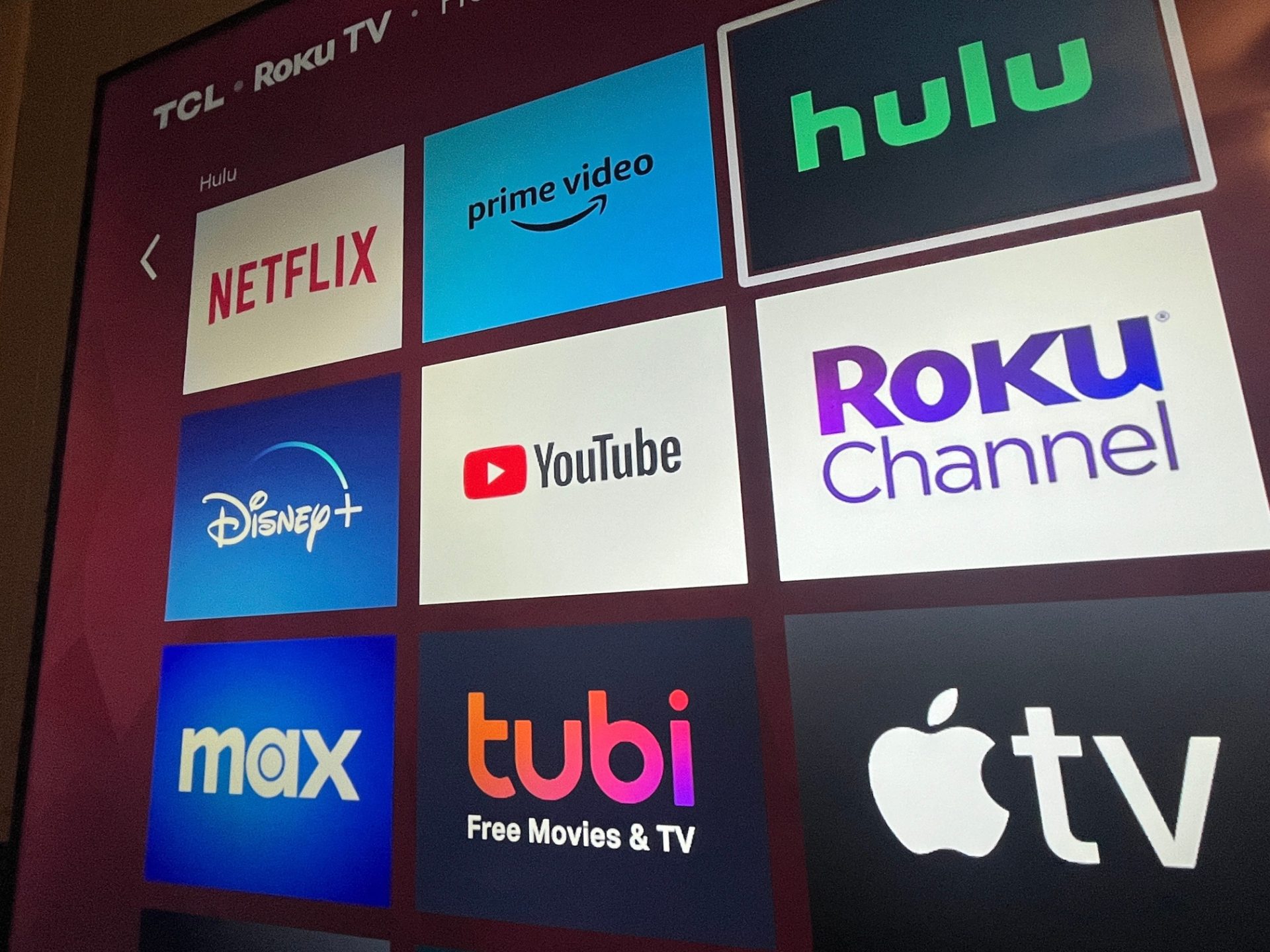 Multiple streaming services appear on a Roku TV.