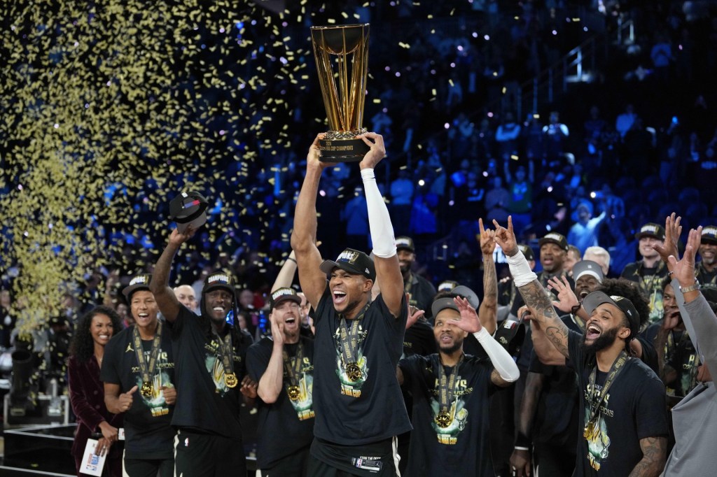 Dec 17, 2024; Las Vegas, Nevada, USA; Milwaukee Bucks forward Giannis Antetokounmpo (34) celebrates with the trophy and teammates after winning the Emirates NBA Cup championship game against the Oklahoma City Thunder at T-Mobile Arena.