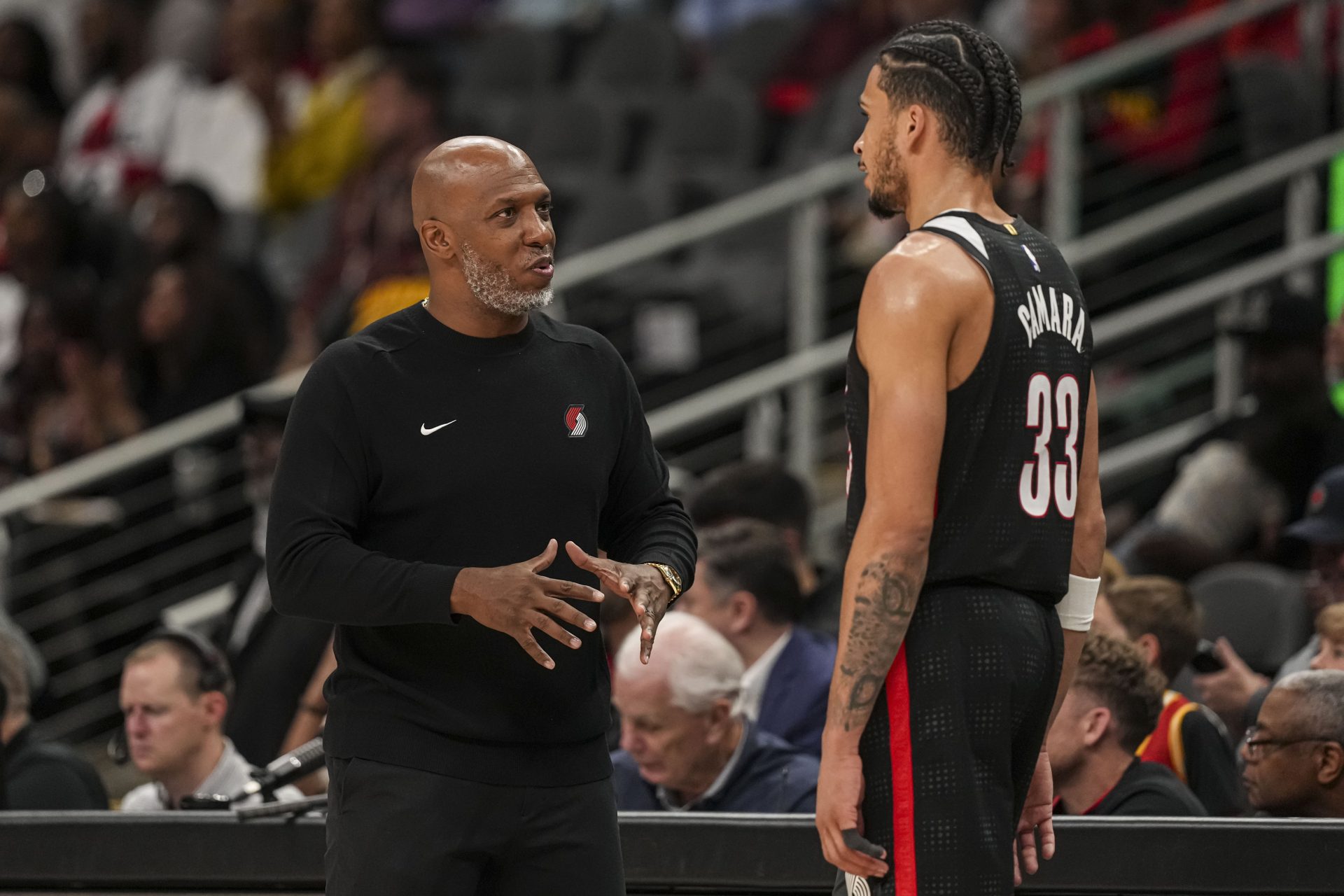 Apr 1, 2025; Atlanta, Georgia, USA; Portland Trail Blazers head coach Chauncey Billups talks to forward Toumani Camara (33) during the game against the Atlanta Hawks during the second half at State Farm Arena.