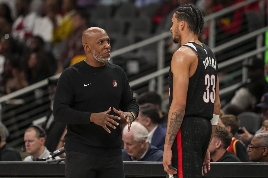 Apr 1, 2025; Atlanta, Georgia, USA; Portland Trail Blazers head coach Chauncey Billups talks to forward Toumani Camara (33) during the game against the Atlanta Hawks during the second half at State Farm Arena.