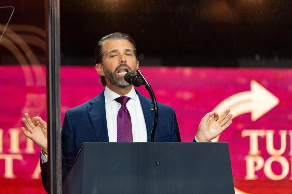 Donald Trump Jr. imitates President Donald Trumps as he speaks during a memorial service honoring Charlie Kirk at State Farm Stadium in Glendale on Sept. 21, 2025.