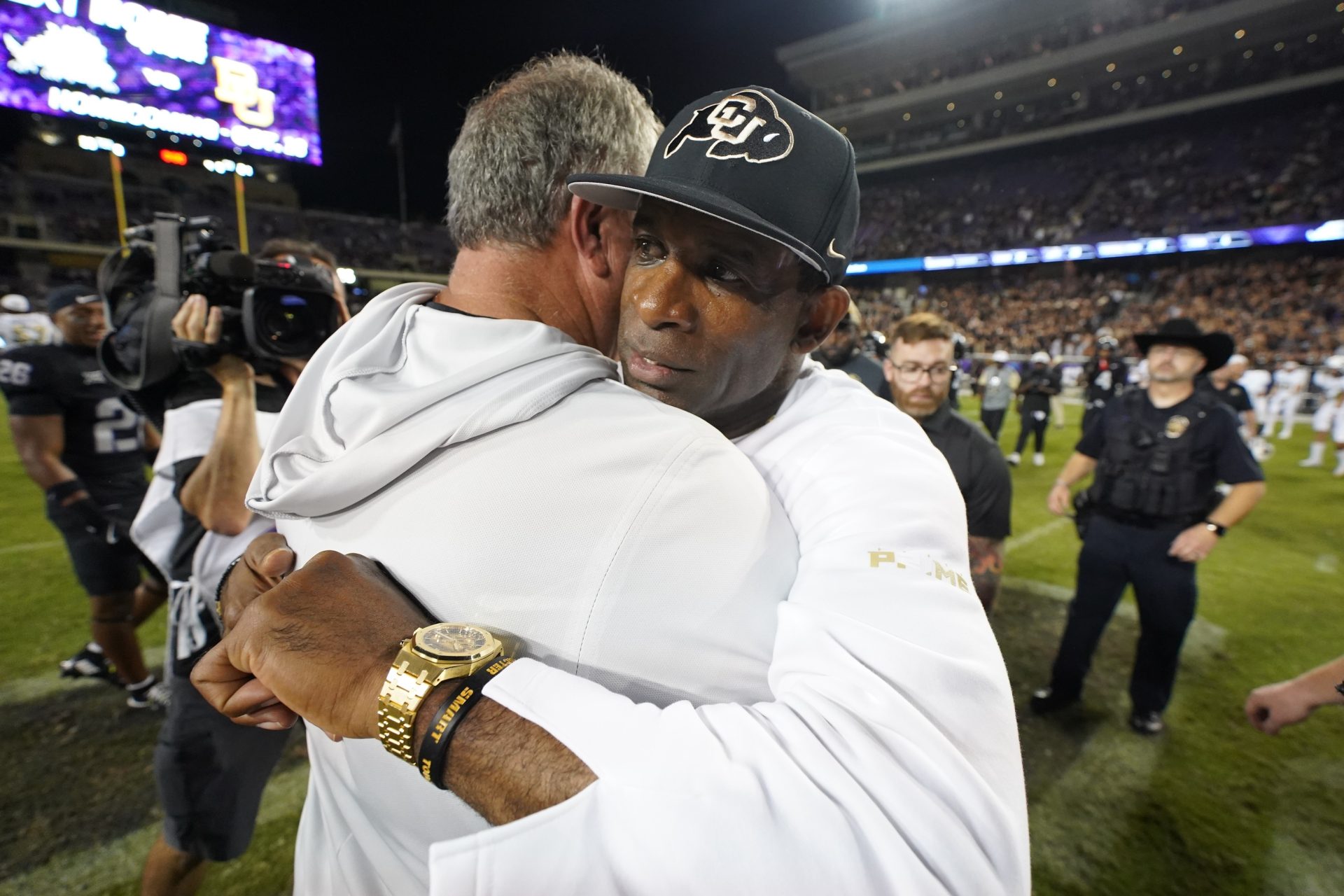 Oct 4, 2025; Fort Worth, Texas, USA; TCU Horned Frogs head coach Sonny Dykes and Colorado Buffaloes head coach Deion Sanders hug following a game at Amon G. Carter Stadium.